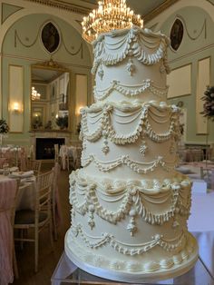 a large white wedding cake sitting on top of a table