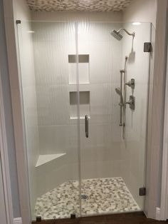 a walk in shower sitting inside of a bathroom