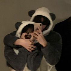 a person in a panda costume taking a selfie