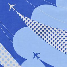 an airplane is flying in the sky with polka dots on it's blue background