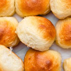 several rolls are arranged on a white surface and ready to be baked in the oven