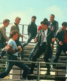 a group of men standing on top of bleachers