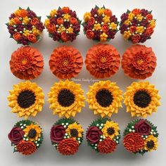 cupcakes decorated with sunflowers and flowers are arranged on a white surface