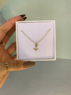 Add a touch of nautical elegance to your look with this Gold Filled Anchor charm necklace. The perfect keepsake for yourself or a loved one, this timeless piece is sure to become a cherished favorite. Let its subtle sophistication adorn your look, and add a touch of maritime mystique to any outfit. 14kt Gold Filled Hypoallergenic Hand made with love Water Resistant Charm size 9.3mm x 14mm Dainty Gold Jewelry, Anchor Charm, Anchor Necklace, Nautical Jewelry, Adjustable Necklace, Gold Filled Jewelry, 14kt Gold, Cable Chain, Made With Love