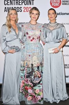 three women standing next to each other in front of a white wall with the words centrepoint awards on it