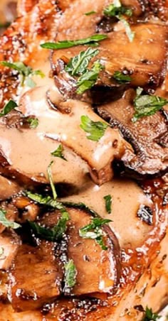 a close up of some meat with mushrooms on it