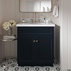 a bathroom with a sink, mirror and rug on the floor in front of it