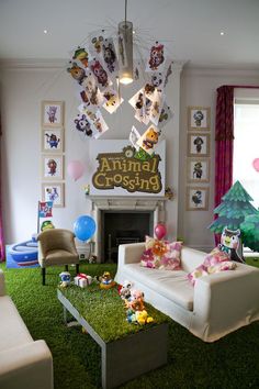 a living room filled with furniture and pictures on the wall