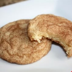 two cookies that are on a white plate