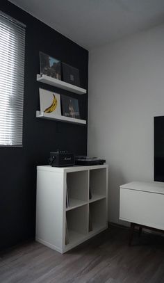 a white entertainment center in a black and white living room