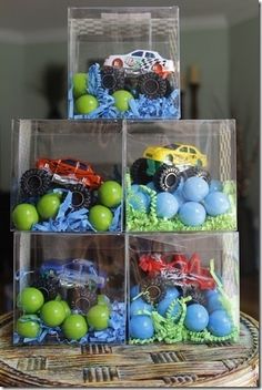 four plastic bins filled with toy trucks and balls