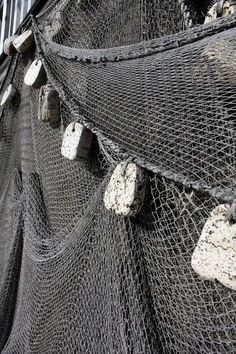 there are several pieces of fishing nets on the wall and in front of an apartment building