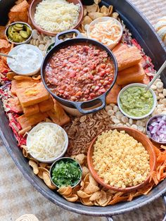 a platter filled with lots of different foods and dips on top of it