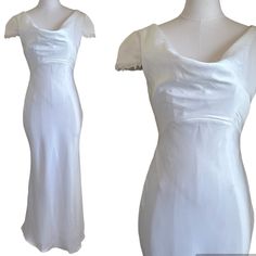 a white dress is shown on a mannequin headdress, and the image shows