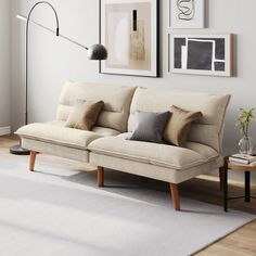 a living room filled with furniture and pictures on the wall above it's couch