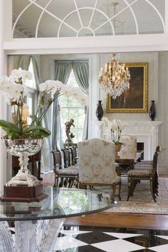 an elegant dining room with chandelier and chairs