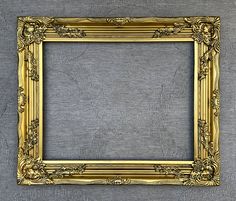 an ornate gold frame on a gray background