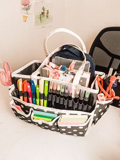 an organized desk with pens, scissors and other office supplies in a polka dot basket