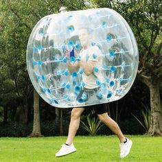 a man is running in a large bubble ball