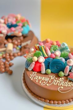 a birthday cake decorated with candies and lollipops