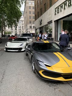 some very nice looking cars parked in the street