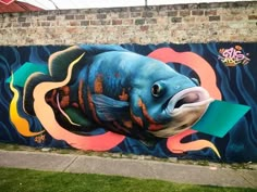 a large fish painted on the side of a building