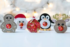 christmas decorations with penguins and reindeers in the background