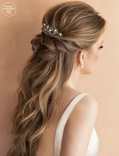 a woman with long hair in a ponytail wearing a bridal hairstyle and a pearled headpiece