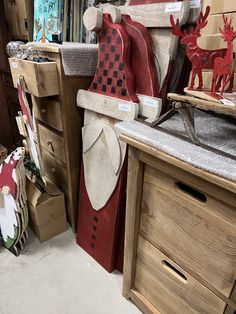 several wooden reindeers are on display in a shop with other christmas decorations and gifts