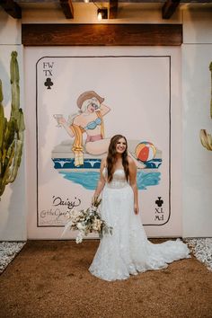 a woman standing in front of a mural