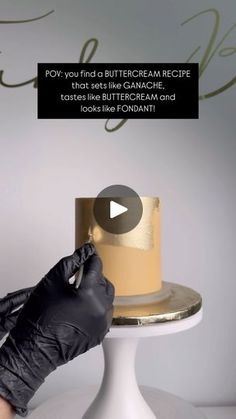 a person in black gloves is cutting a cake on a white pedestal with the words pov you find a buttercream recipe