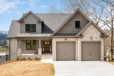 a large house with two garages in the front and one on the other side