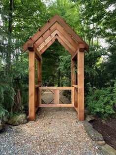 a wooden gazebo sitting in the middle of a forest