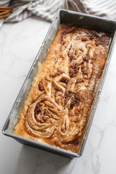 a pan filled with cinnamon rolls on top of a counter