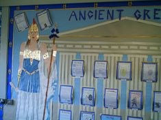 a blue and white bulletin board with an image of a woman holding a staff in front of it