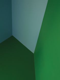 the corner of a room with green and blue walls