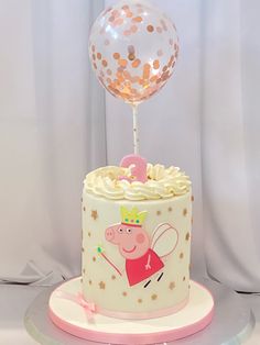 a peppa pig birthday cake with a balloon on top