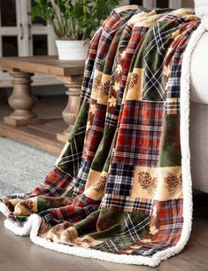 a plaid blanket sitting on top of a white couch