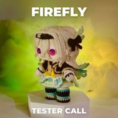 a crocheted doll sitting on top of a white block with the words firefly written above it