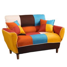 a multicolored couch sitting on top of a white floor