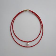 < Red coral necklace with pearl pendant > This product made according to the model of authentic traditional Ukrainian jewelry. The coral is modern, the design is vintage. Like 99% of the coral on the market these days, this coral has been dyed. I use bamboo coral which is not endangered or threatened in any way, unlike natural pink or red coral (the production of which is forbidden almost everywhere in the world). Bamboo coral doesn't mean it's not organic. Every bead of it has a distincti Red Bead Necklace, Coral Necklace Designs, Red Beads Jewellery, Pearl And Coral Necklace, Ukrainian Jewelry, Red Coral Jewellery, Necklace With Pearl, Red Beaded Necklaces, Pendant Minimalist