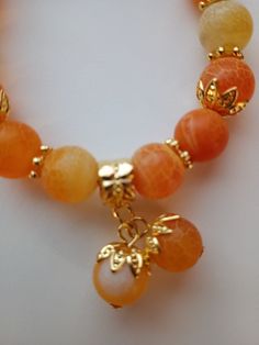 10mm orange crackle agate with bead bobble charms7.78 inch stretch bracelet Cheap Orange Beaded Bracelets, Cheap Orange Bead Bracelets, Adjustable Orange Agate Bracelet, Adjustable Orange Agate Bracelets, Orange Beaded Bracelet With Natural Stones, Orange Agate Gemstone Bead Bracelets, Orange Agate Gemstone Beads Bracelet, Orange Stretch Bracelet With 8mm Beads, Orange Stretch Bracelet With Large Beads As Gift