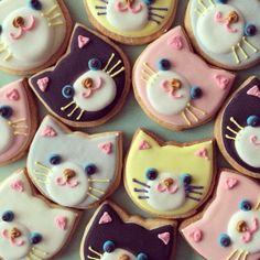 many decorated cookies with cats on them