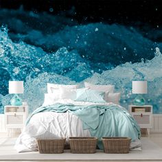 an ocean themed bedroom with blue and white waves on the wall, two wicker baskets under the bed