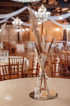 the centerpieces in this wedding reception are made from dried flowers and pamodia