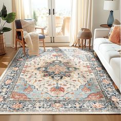 a living room filled with furniture and a large rug