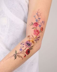 a woman with a flower tattoo on her arm