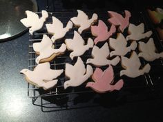 some decorated cookies are on a rack with a mirror in the backgrouf