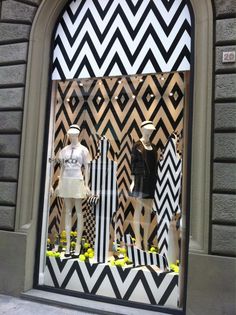 a window display with mannequins dressed in black and white