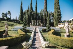 an outdoor wedding setup with white flowers and greenery